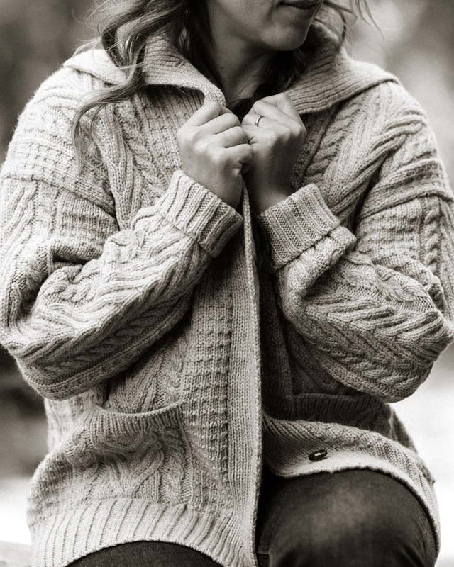 Woman in oversize cable knit cardigan